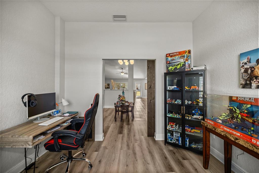 4160 Southwest 100th Street Ocala, FL 34476 - Photo 13 of 42 a view of a workspace with furniture and wooden floor