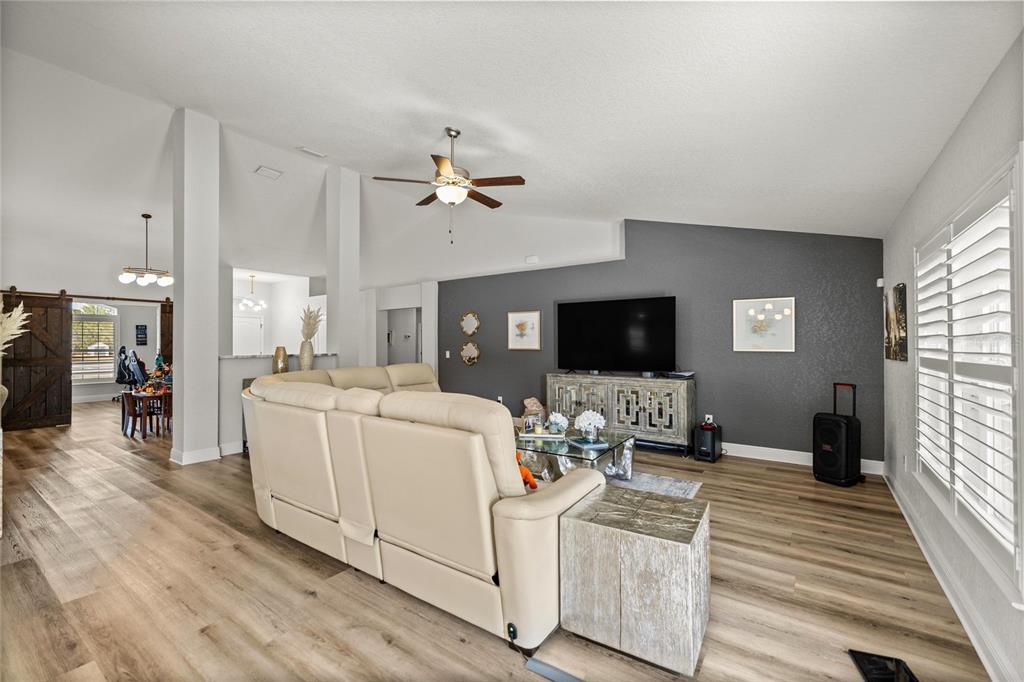 4160 Southwest 100th Street Ocala, FL 34476 - Photo 17 of 42 a living room with furniture and a flat screen tv