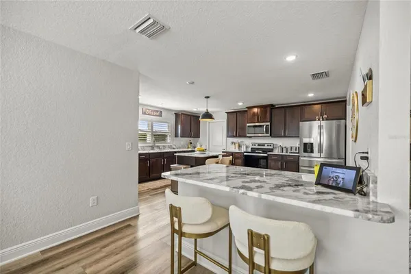 a kitchen with refrigerator and cabinets