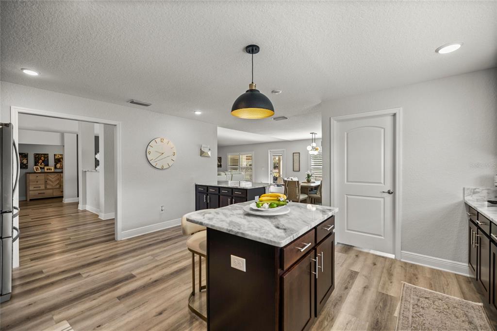 4160 Southwest 100th Street Ocala, FL 34476 - Photo 21 of 42 a view of a kitchen area with furniture and wooden floor