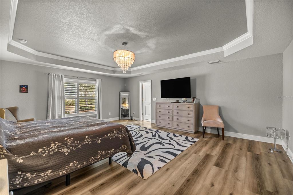 4160 Southwest 100th Street Ocala, FL 34476 - Photo 23 of 42 a view of a bedroom with wooden floor and a window