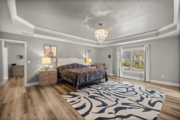 a bedroom with a large bed and a window
