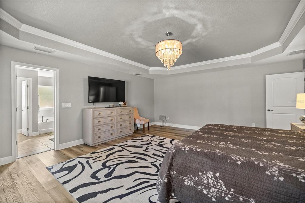 4160 Southwest 100th Street Ocala, FL 34476 - Photo 25 of 42 a bedroom with a bed and a flat screen tv