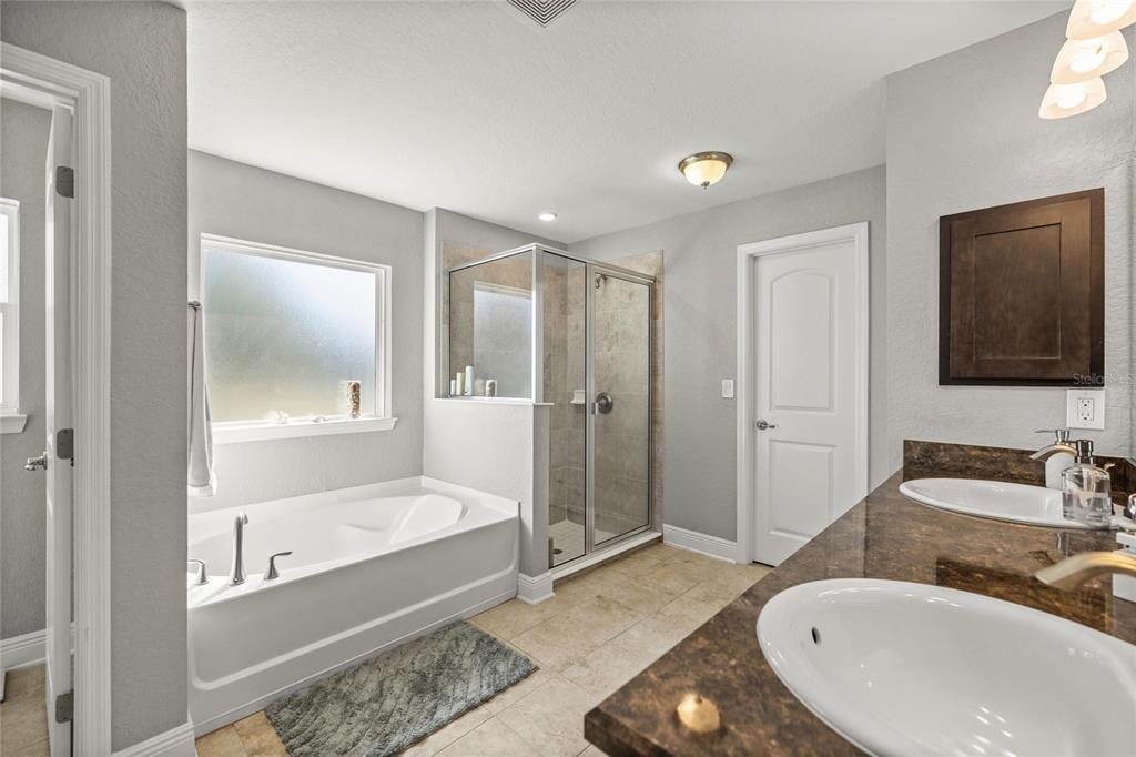 4160 Southwest 100th Street Ocala, FL 34476 - Photo 26 of 42 a bathroom with a tub and a sink