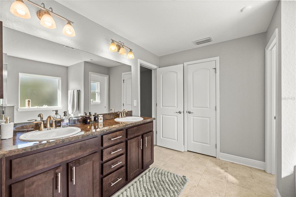 4160 Southwest 100th Street Ocala, FL 34476 - Photo 27 of 42 a bathroom with double vanity sinks and a mirror