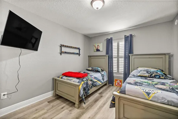 a bedroom with a bed and a flat screen tv