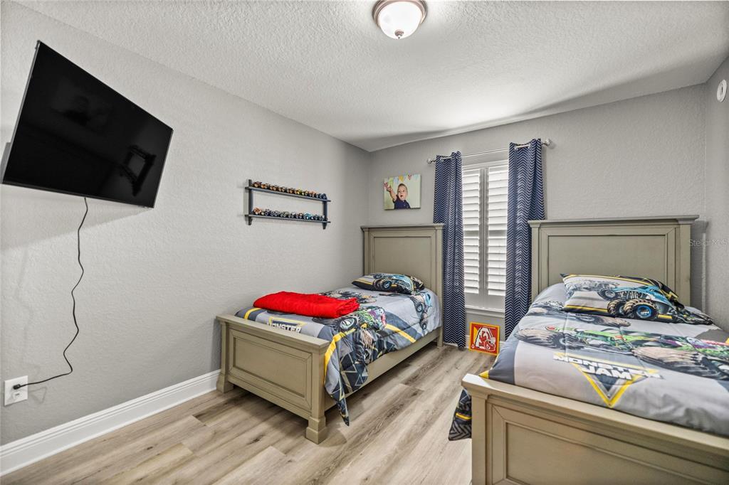 4160 Southwest 100th Street Ocala, FL 34476 - Photo 31 of 42 a bedroom with a bed and a flat screen tv