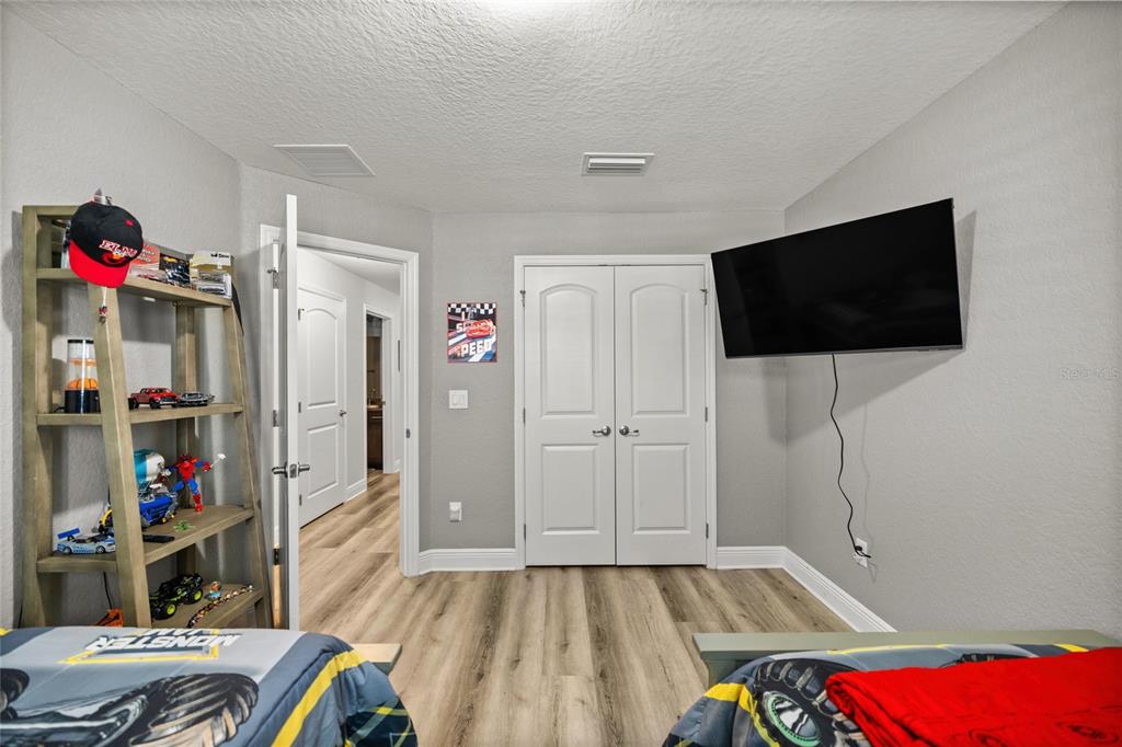 4160 Southwest 100th Street Ocala, FL 34476 - Photo 32 of 42 a very nice looking bedroom with a bed and a flat screen tv