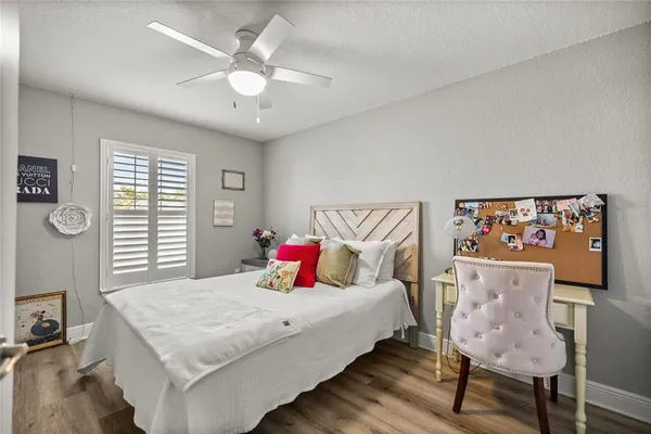 a bedroom with a bed and a table with chair