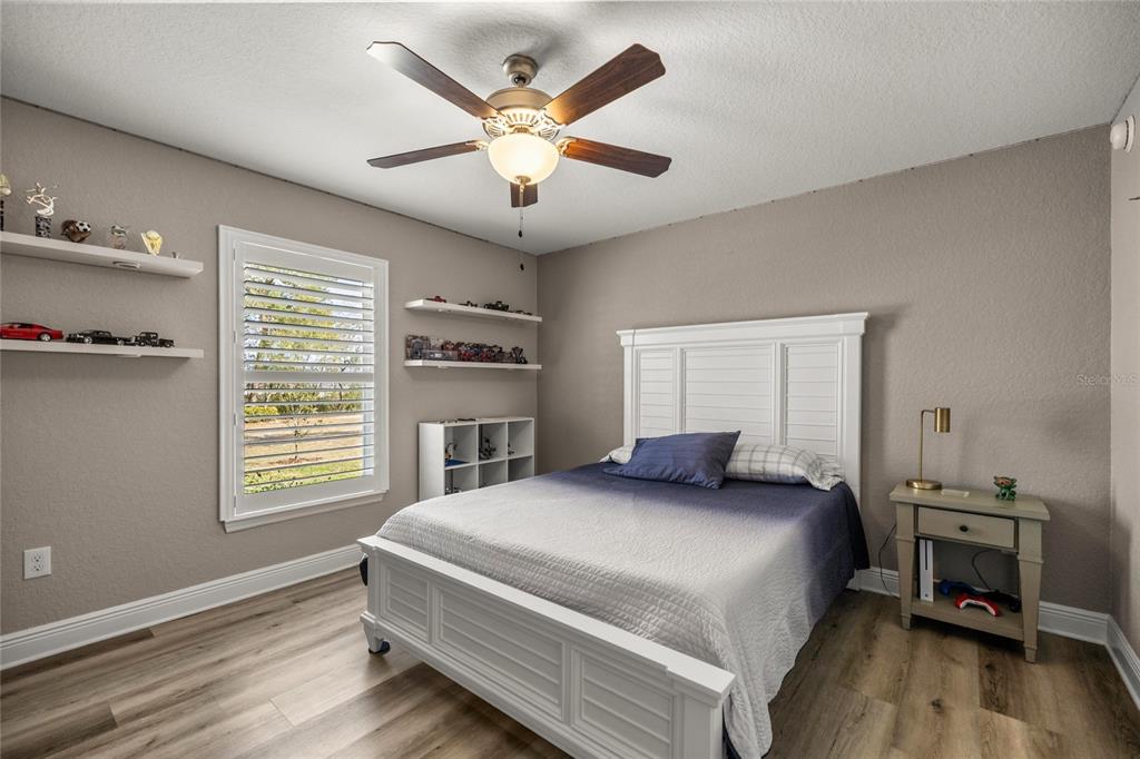4160 Southwest 100th Street Ocala, FL 34476 - Photo 35 of 42 a bedroom with a large bed and a window