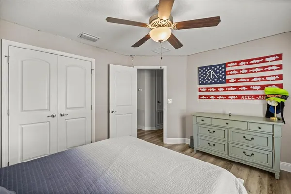 a bedroom with a bed and a dresser in it