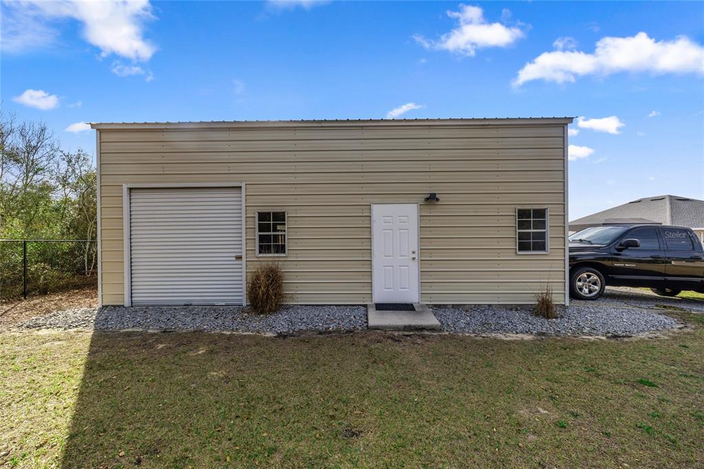 4160 Southwest 100th Street Ocala, FL 34476 - Photo 40 of 42 a view of a house with a yard