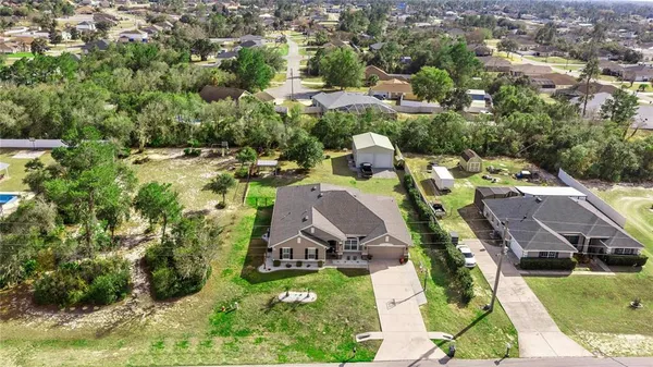 an aerial view of a house with yard swimming pool and outdoor seating