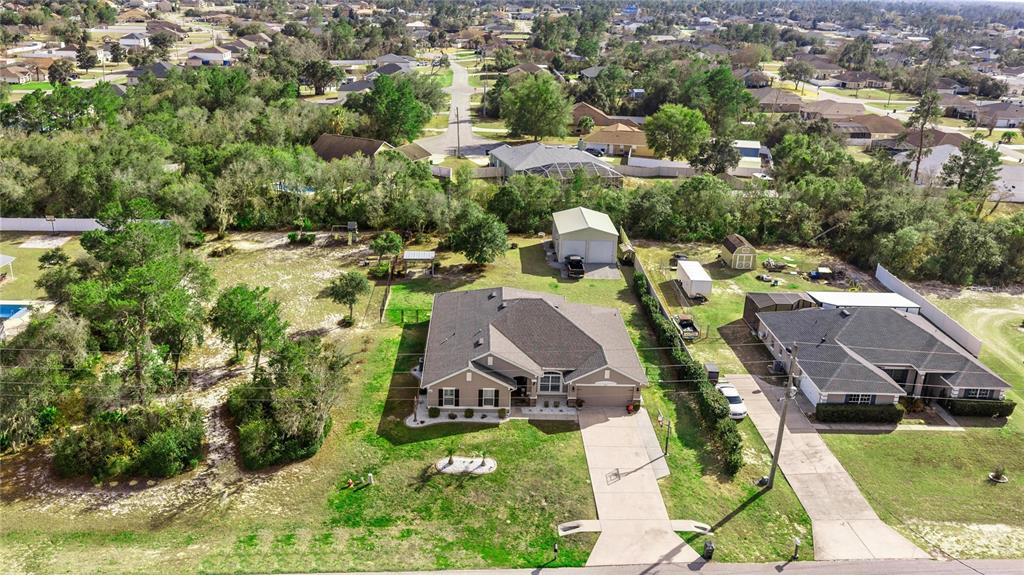 4160 Southwest 100th Street Ocala, FL 34476 - Photo 4 of 42 an aerial view of a house with yard swimming pool and outdoor seating