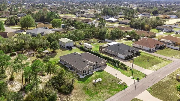 an aerial view of residential houses with outdoor space and street view