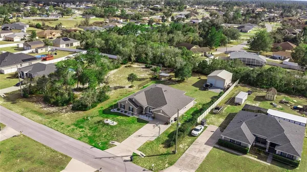 an aerial view of a house with yard swimming pool and outdoor seating