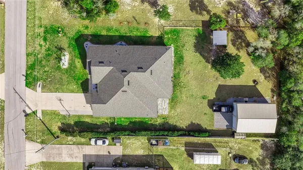 an aerial view of a house with yard swimming pool and outdoor seating