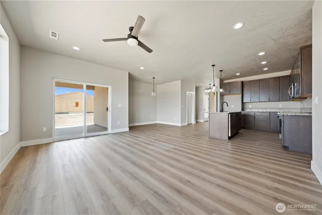 a view of a kitchen with a sink and wooden floor