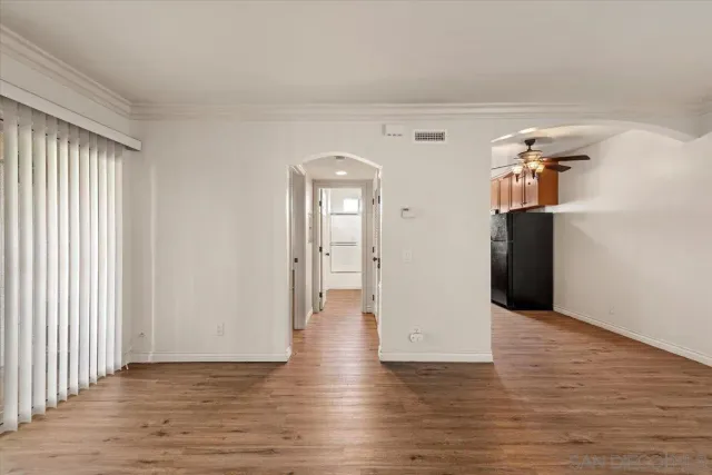 a view of a room with wooden floor and cabinet
