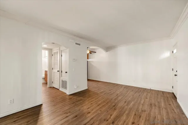 a view of a room with wooden floor