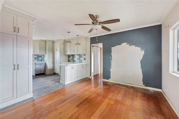a view of a kitchen with wooden floor and a kitchen