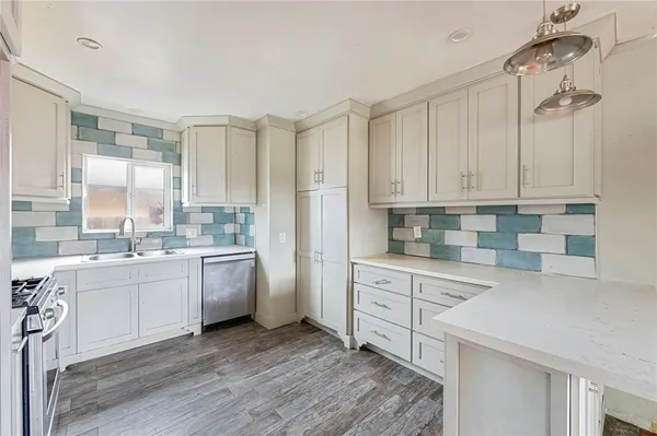 a kitchen with white cabinets and white appliances