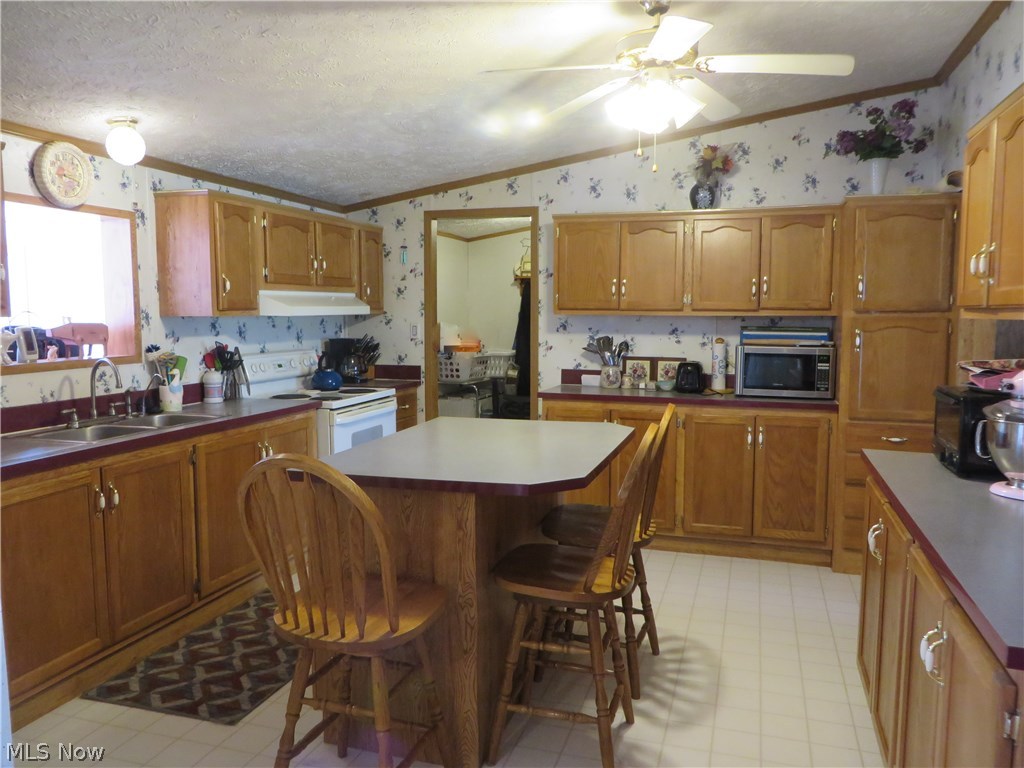 15335 Moseley Road Madison, OH 44057 - Photo 5 of 34 Main home kitchen with island perfect for eating area or extra cooking and baking space.