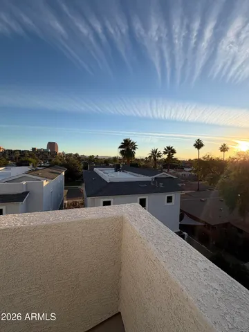 a kitchen with a stove a refrigerator a sink a dining table and chairs with wooden floor