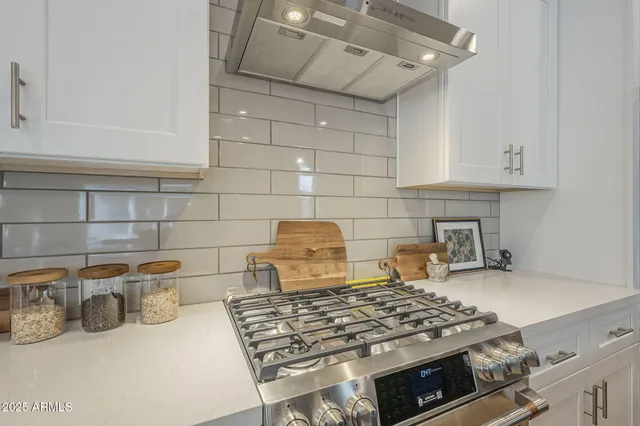 a kitchen with a stove and cabinets