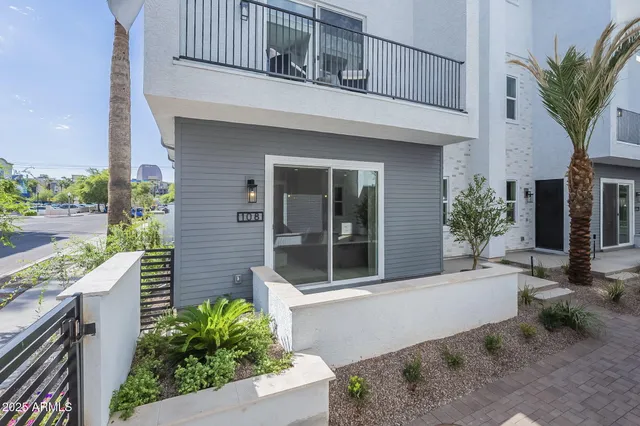 a kitchen with stainless steel appliances white cabinets and a stove top oven