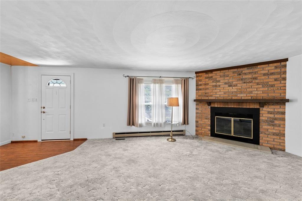 1017 Nellie Road Vanderbilt, PA 15486 - Photo 19 of 31 an empty room with a fireplace and window