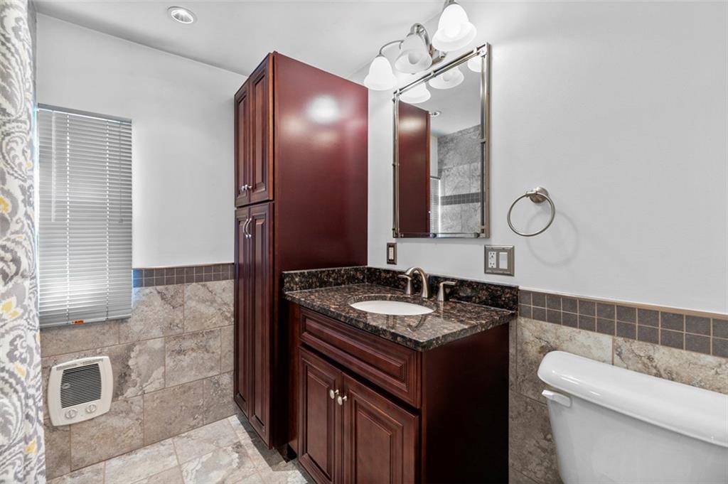 1017 Nellie Road Vanderbilt, PA 15486 - Photo 27 of 31 a bathroom with a sink a toilet and a mirror