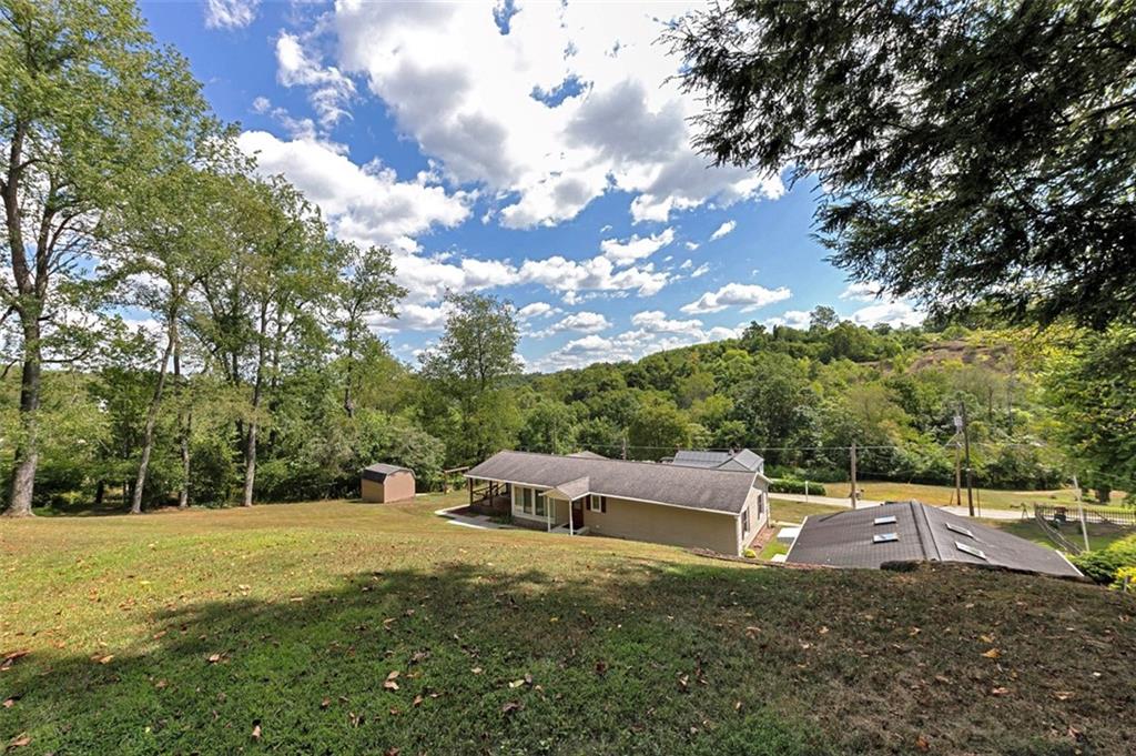 1017 Nellie Road Vanderbilt, PA 15486 - Photo 9 of 31 a backyard of a house with lots of green space