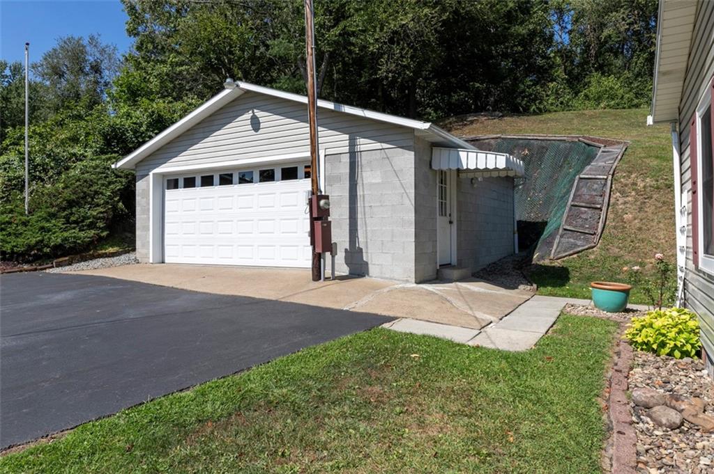1017 Nellie Road Vanderbilt, PA 15486 - Photo 10 of 31 a front view of a house with a yard and garage
