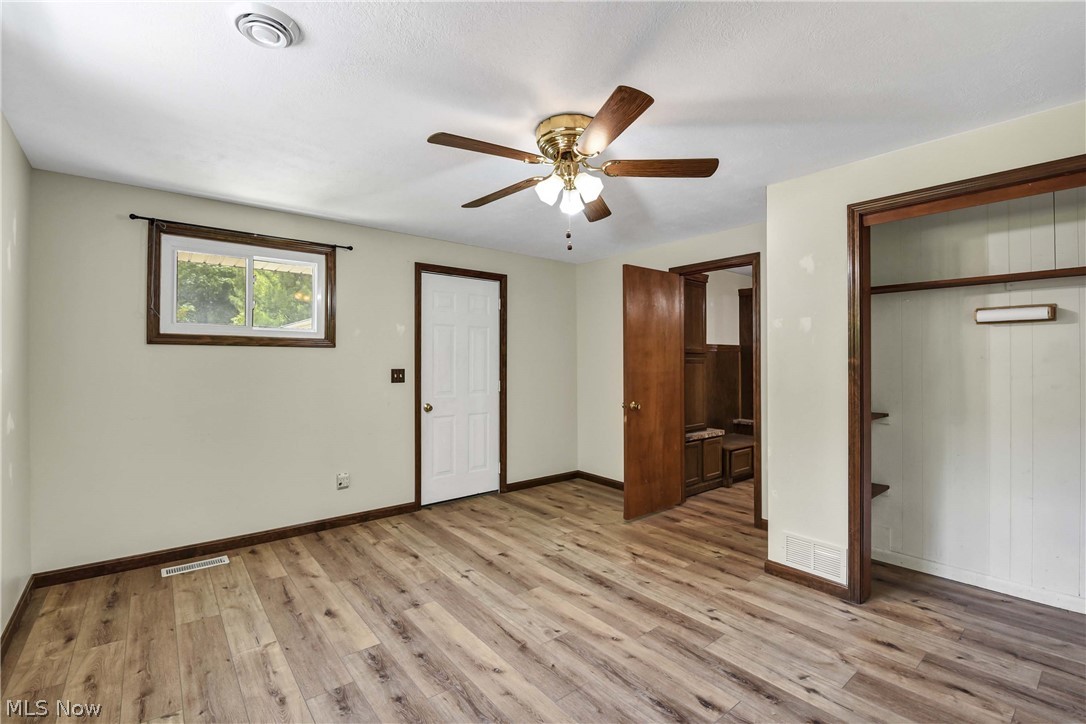 301 Crosse Road Amherst, OH 44001 - Photo 36 of 49 Room featuring wood-finish flooring, a ceiling fan with light fixture, and light-toned walls