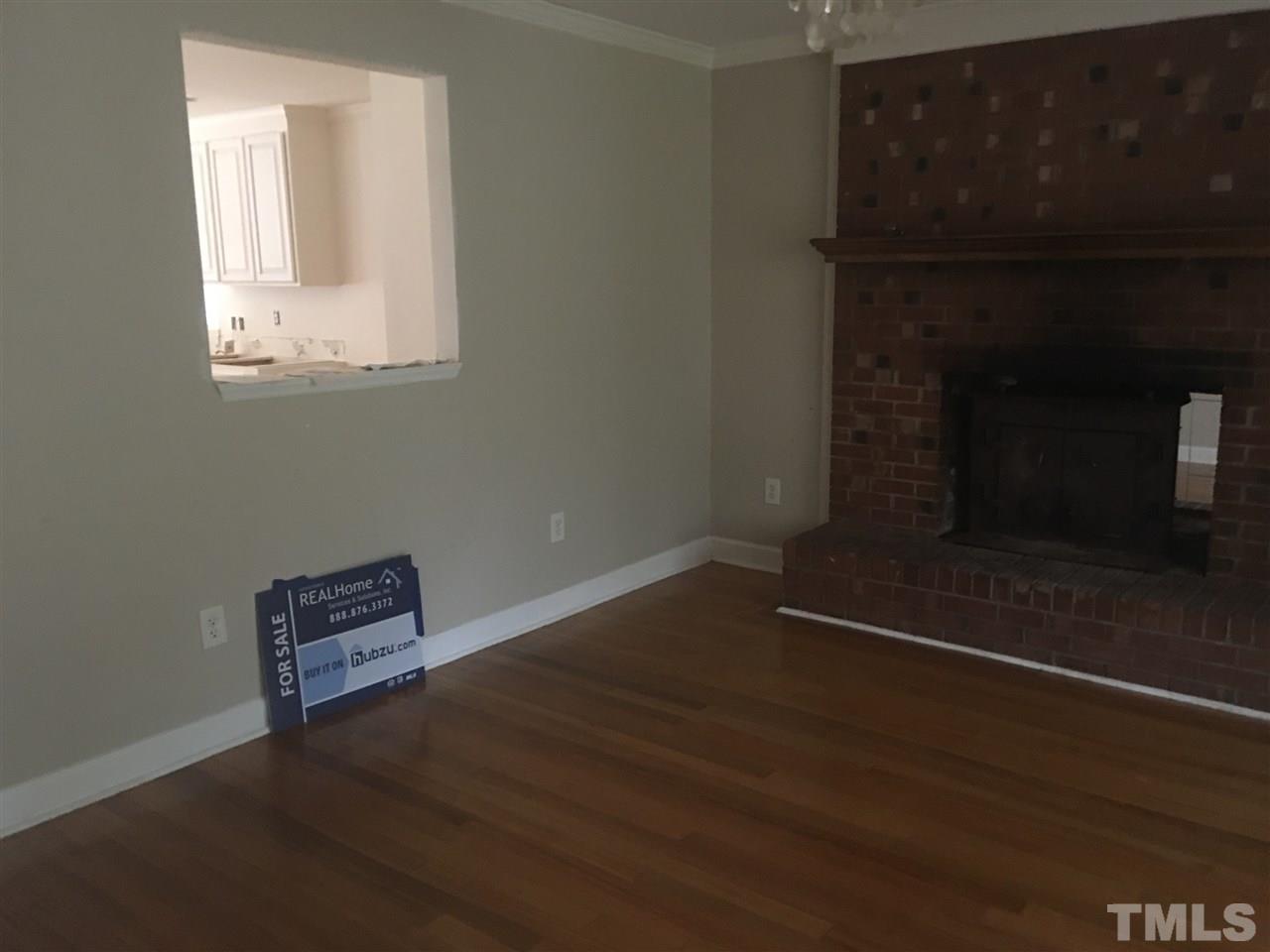1425 Goodwin Road Apex, NC 27523 - Photo 2 of 23 an empty room with wooden floor and windows