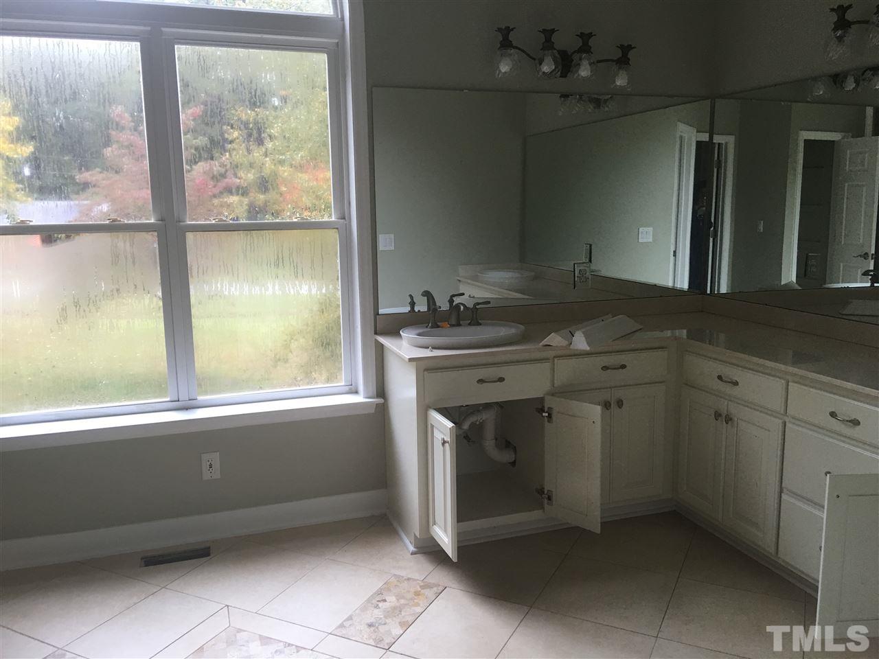 1425 Goodwin Road Apex, NC 27523 - Photo 12 of 23 a utility room with a sink window and cabinets