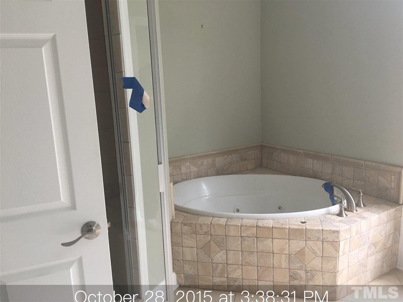 1425 Goodwin Road Apex, NC 27523 - Photo 15 of 23 a bath tub sitting next to a white sink