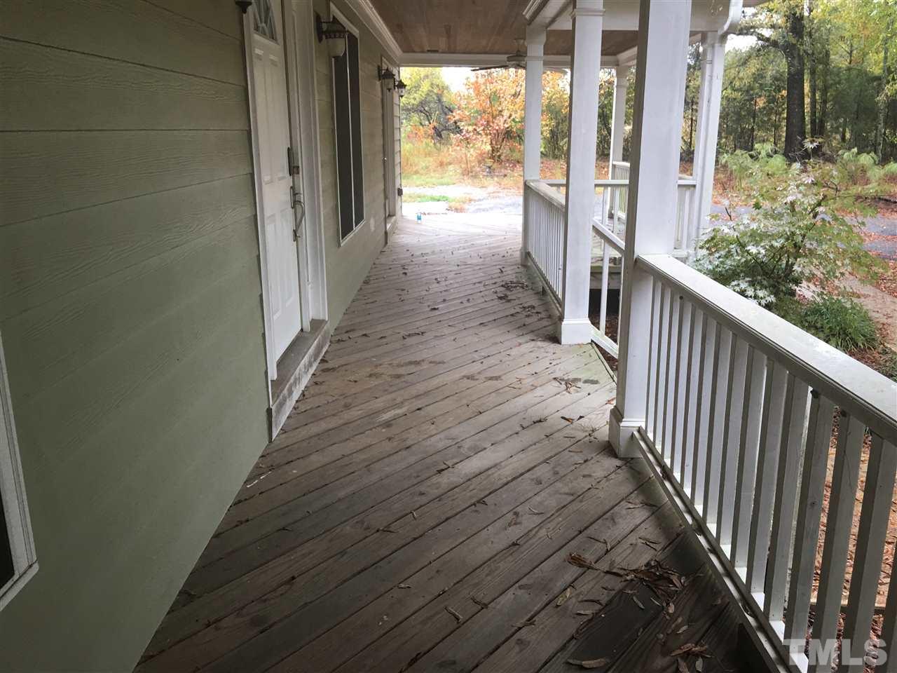 1425 Goodwin Road Apex, NC 27523 - Photo 21 of 23 a view of a porch with wooden floor and stairs