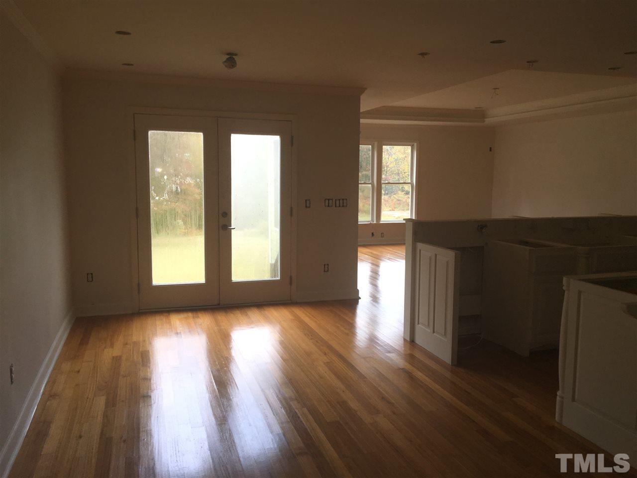 1425 Goodwin Road Apex, NC 27523 - Photo 4 of 23 a view of an empty room with wooden floor and a window