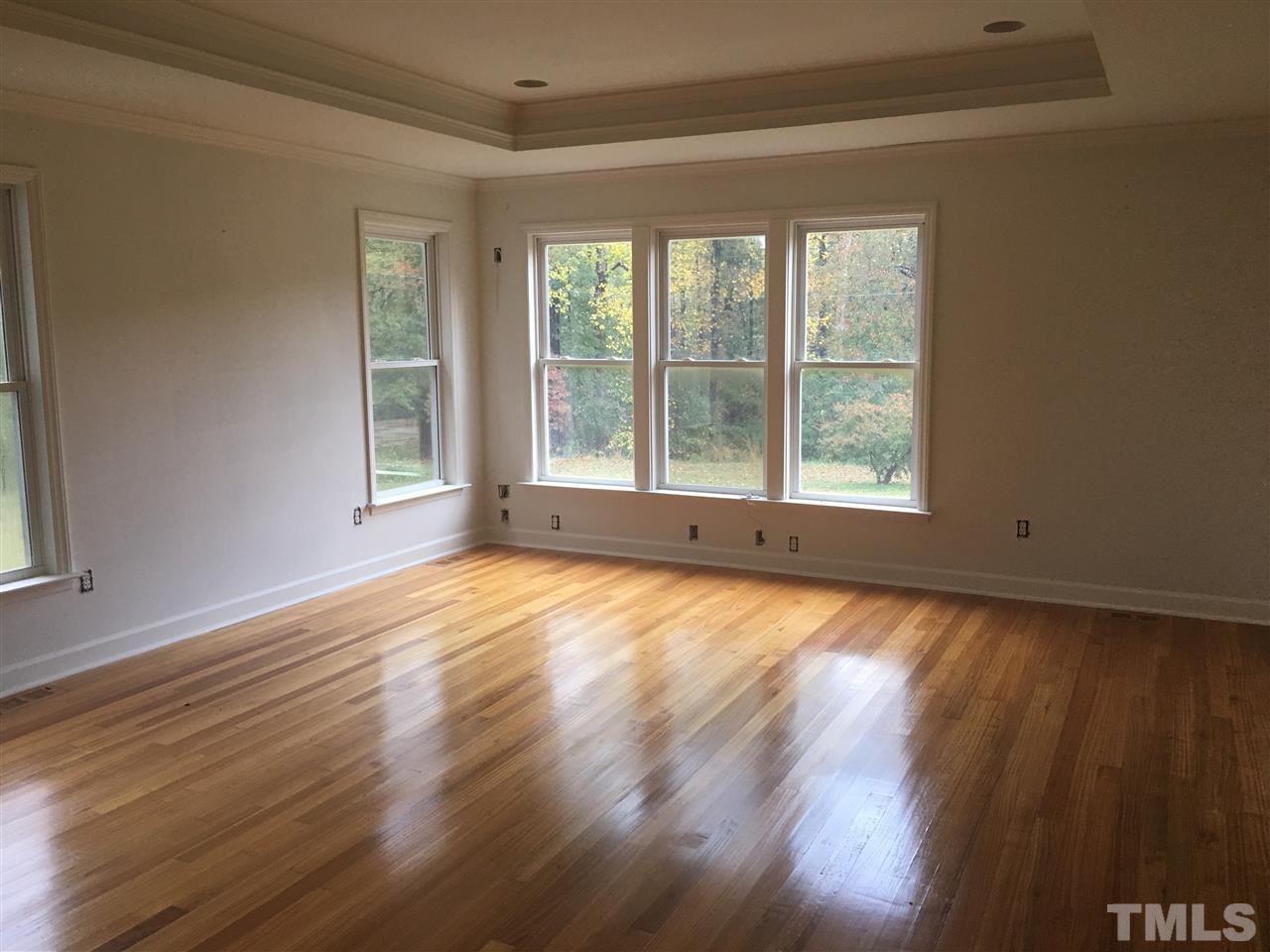 1425 Goodwin Road Apex, NC 27523 - Photo 5 of 23 a view of an empty room with wooden floor and a window