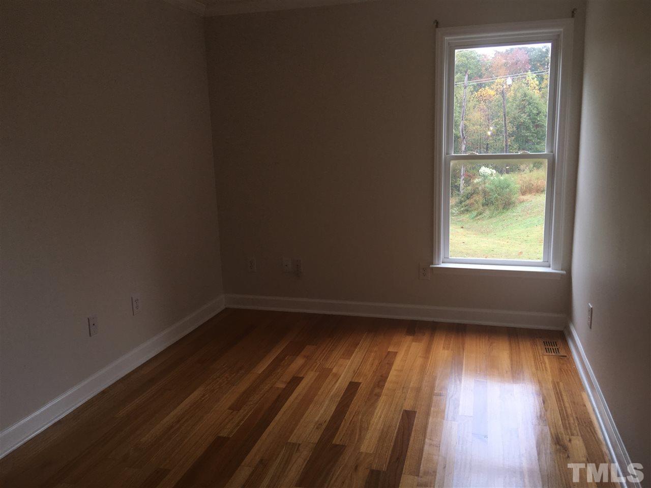 1425 Goodwin Road Apex, NC 27523 - Photo 7 of 23 a view of an empty room with wooden floor and a window