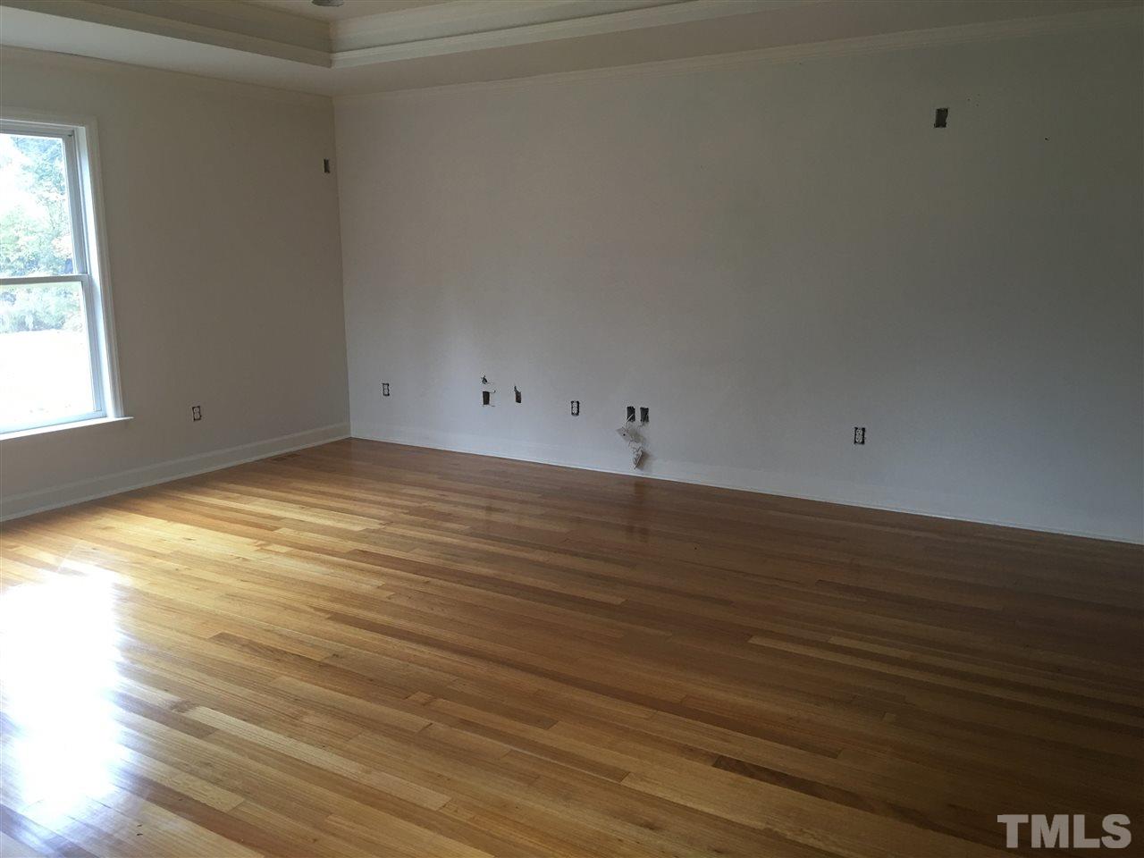 1425 Goodwin Road Apex, NC 27523 - Photo 8 of 23 a view of a room with wooden floor and white walls