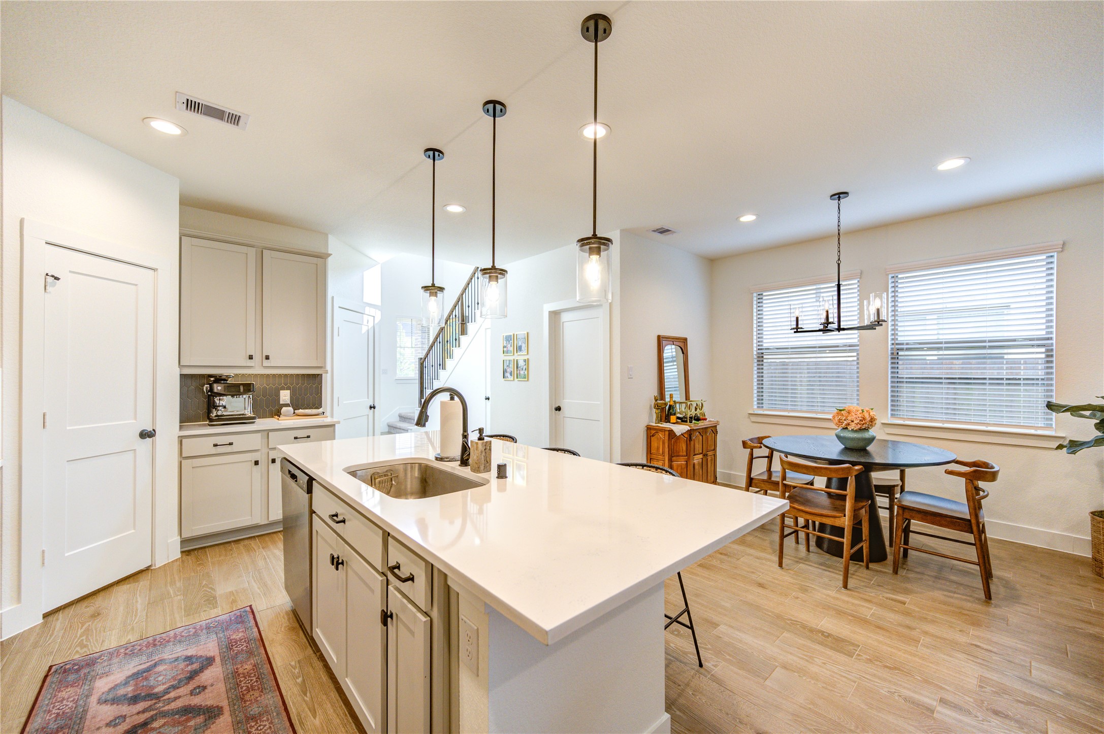 17758 Tree Of Heaven Conroe, TX 77385 - Photo 11 of 44 a kitchen with a table chairs sink and cabinets