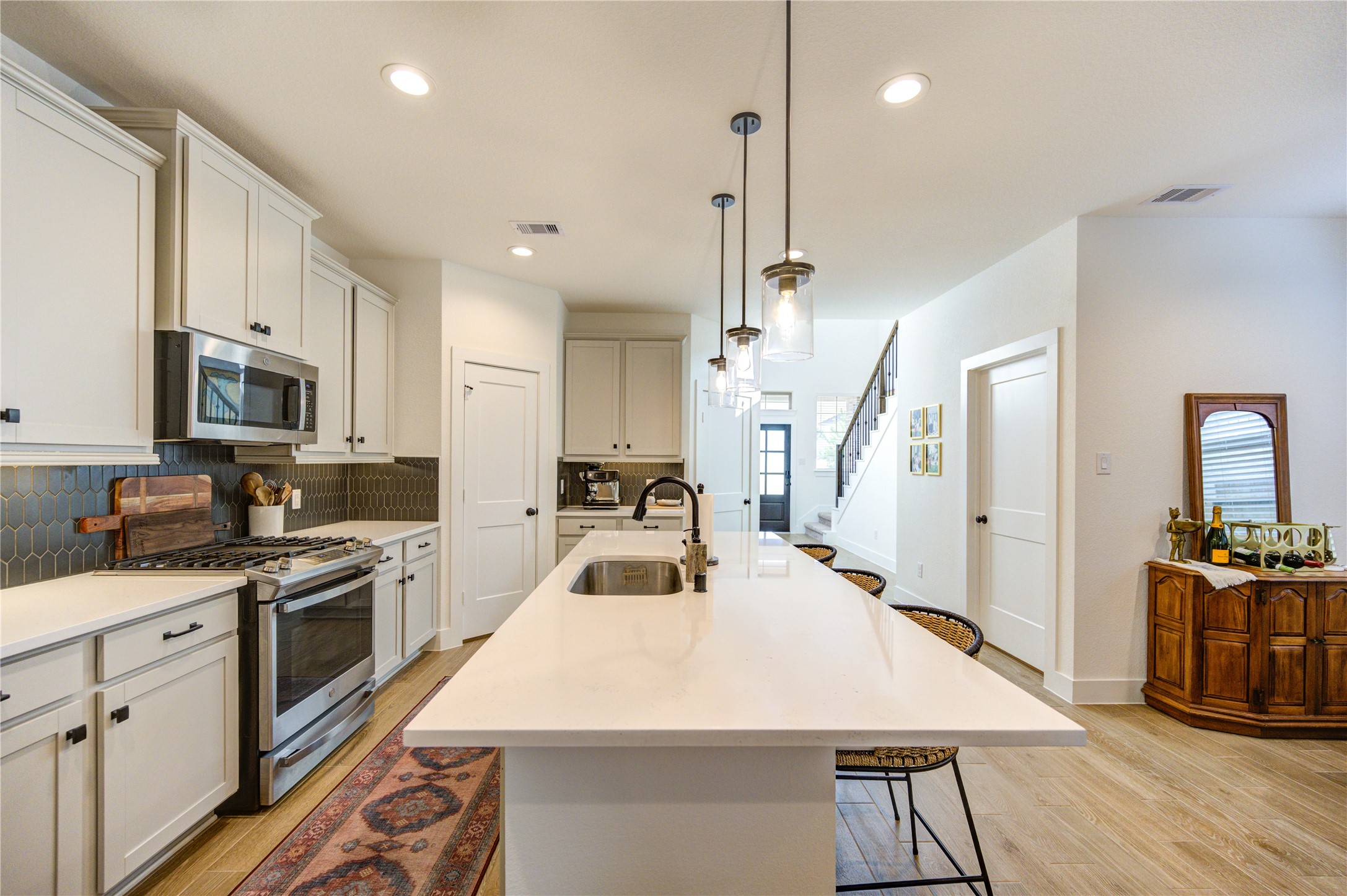 17758 Tree Of Heaven Conroe, TX 77385 - Photo 15 of 44 a kitchen with sink a stove and refrigerator