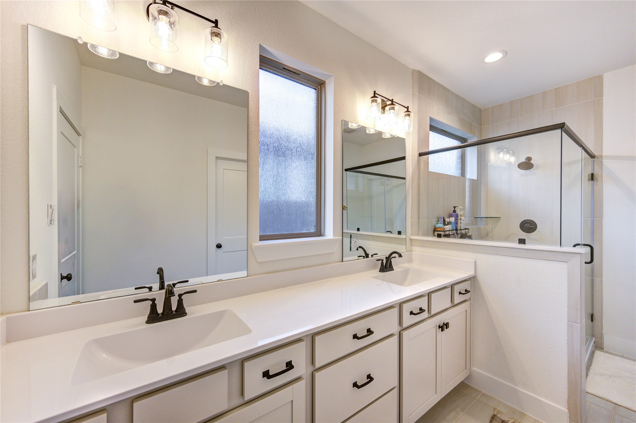 17758 Tree Of Heaven Conroe, TX 77385 - Photo 25 of 44 a bathroom with double sink and a mirror