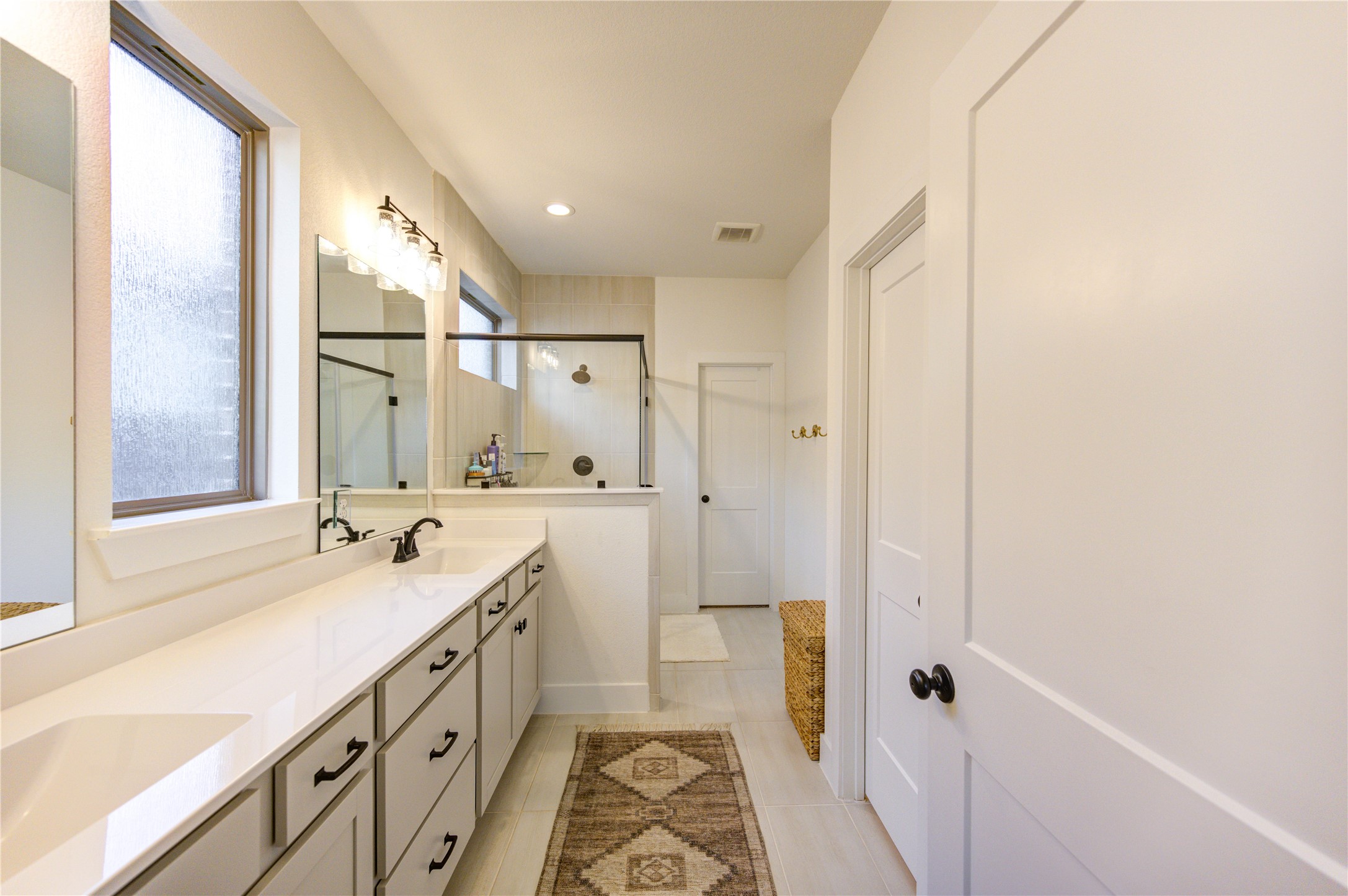 17758 Tree Of Heaven Conroe, TX 77385 - Photo 27 of 44 a spacious bathroom with a shower sink and mirror