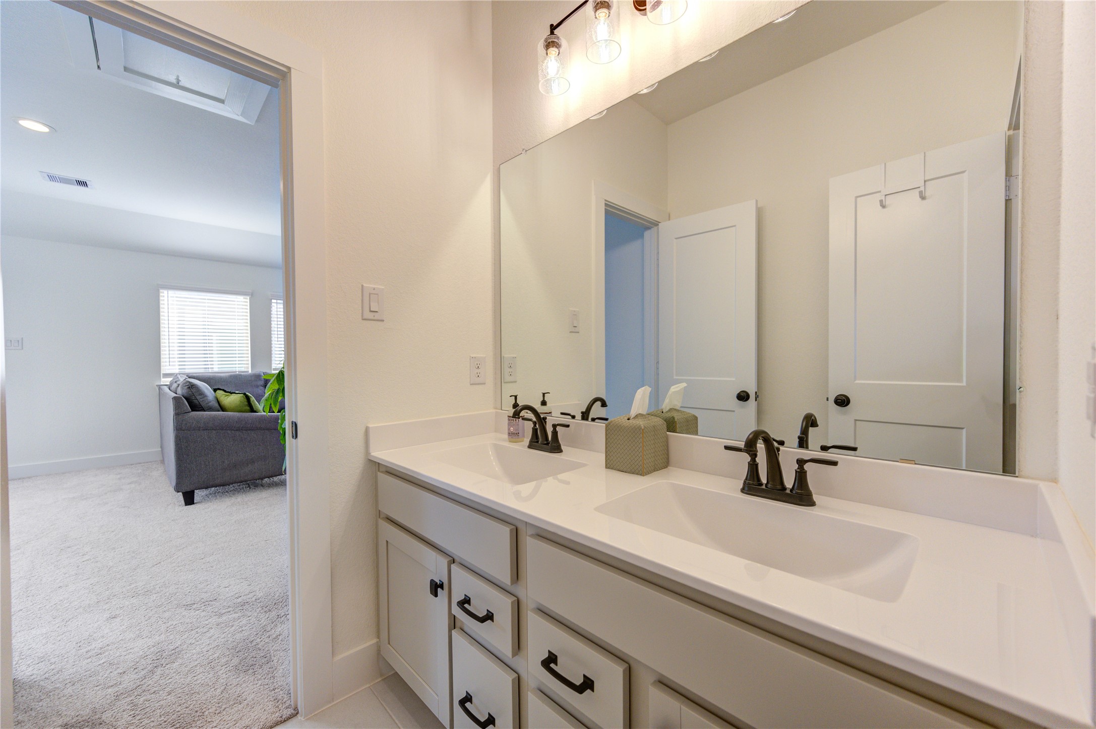 17758 Tree Of Heaven Conroe, TX 77385 - Photo 35 of 44 a bathroom with double sink and a mirror
