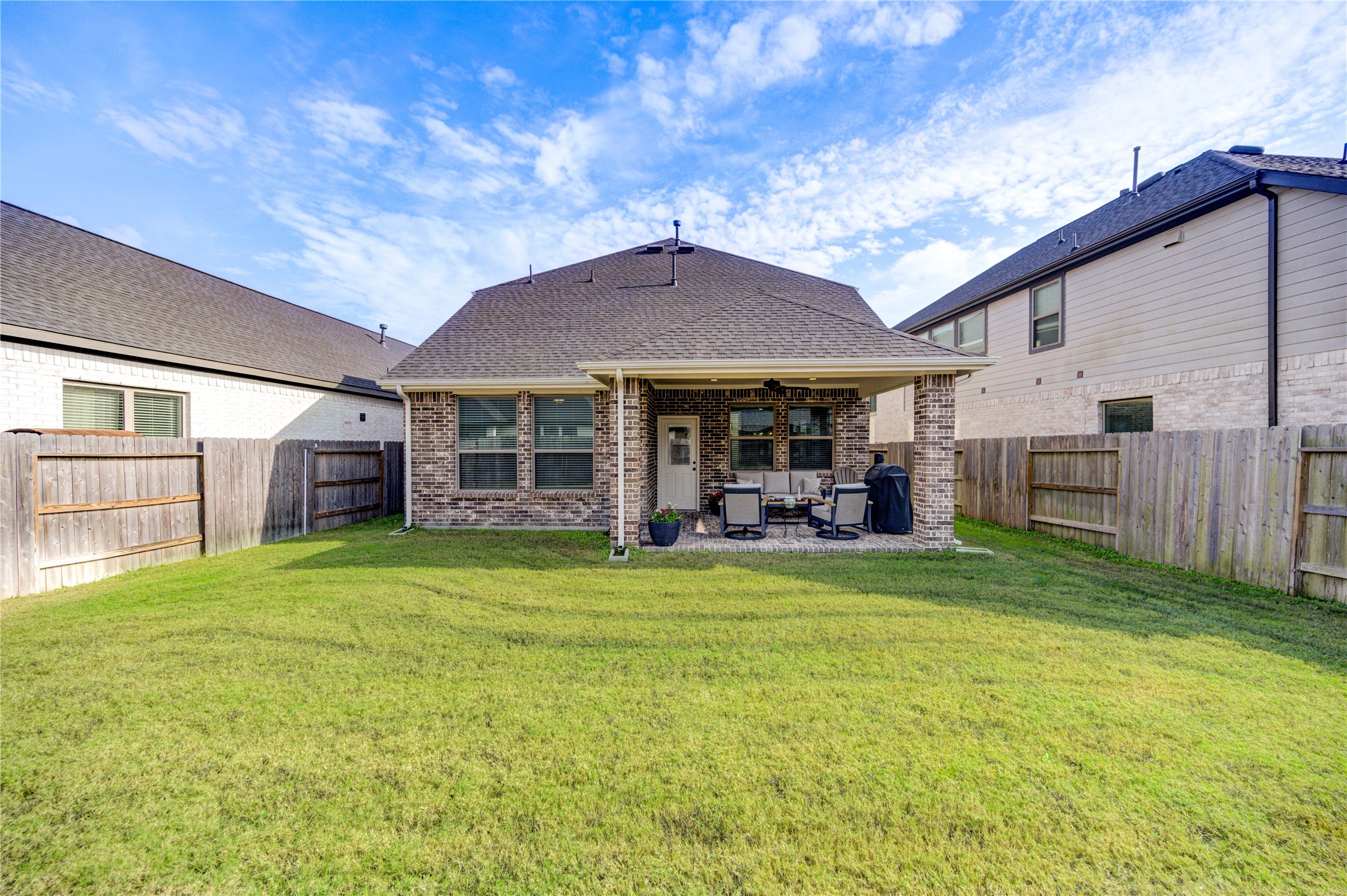 17758 Tree Of Heaven Conroe, TX 77385 - Photo 42 of 44 a view of a house with backyard porch and outdoor seating
