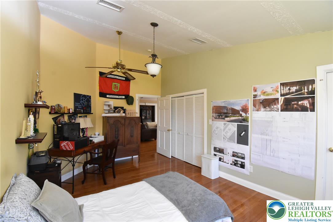424 Grape Street Whitehall, PA 18052 - Photo 47 of 56 This spacious bedroom features warm wood flooring and a classic ceiling fan, offering comfortable living.